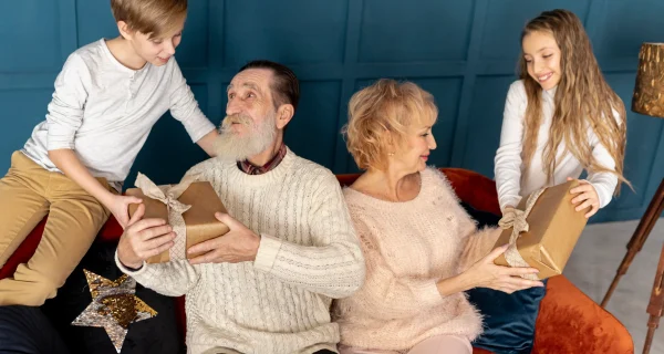 front-view-grandchildren-giving-their-grandparents-gifts